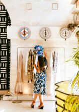 Elegant woman with a turban exploring fashion choices in a stylish New York boutique.